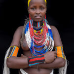 Adorned with intricate decorations, this young woman carries the elegance and tradition of the Arbore people with grace (image by Ingrid Koedood)