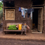 A young Ari girl sitting on a wooden bench in front of her house (image by Ingrid Koedood)