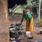 An Ari woman looks up with curiosity while tending to the fire (image by Ingrid Koedood)