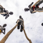 Photo of the Benna boys on their wooden stilts, with me lying on the ground to capture the shot (image by Ingrid Koedood)