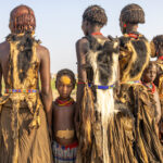 Young girls standing between women of the Dassenech tribe, decorated to celebrate Dimi (image by Ingrid Koedood)