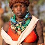 Hamer women coat their hair with a mixture of ochre, butter, and fat, creating their signature braided style (image by Ingrid Koedood)