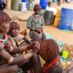 A Hamer woman’s hair is being treated with ochre, butter, and fat, shaping it into the tribe’s iconic style (image by Ingrid Koedood)