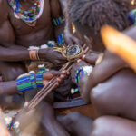 Before the young Hamer man jumps over the bulls, a powerful ritual takes place between men (image by Ingrid Koedood)