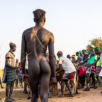The young Hamer man waits with anticipation, ready for the moment when he will jump over the bulls (image by Ingrid Koedood)