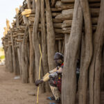 A man sitting in front of the Marmar, a large wooden structure used by Karo elders to have meetings. It is a structure reserved strictly for men (image by Ingrid Koedood)