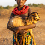 A young Karo girl carrying a little goat (image by Ingrid Koedood)