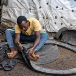 A man demonstrates the art of making sandals from recycled car tires in Konso (image by Ingrid Koedood)