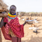 This Nyangatom girl just finished milking the goats, takes a moment to pose for the camera (image by Ingrid Koedood)