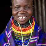 A Nyangatom woman with a beautiful smile in front of her house (image by Ingrid Koedood)