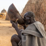 A Nyangatom man drinks coffee from a calabash, a traditional vessel used in many cultures (image by Ingrid Koedood)