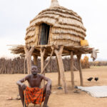A Nyangatom man sitting in front of his granary, locally known as Ekore (image by Ingrid Koedood)