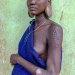 A Suri woman in Kibish town proudly displays the scarifications of her arms, each mark telling a story of tradition, strength and identity (image by Ingrid Koedood)