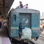 Even the back step of a local train has a smiling passenger (image by Yousuf Tushar)