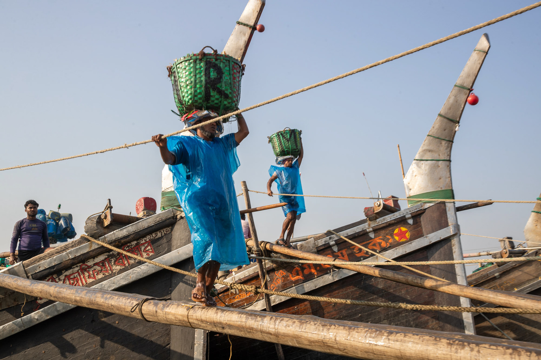 Fish carriers offloading fish from local trawlers (image by Yousuf Tushar)