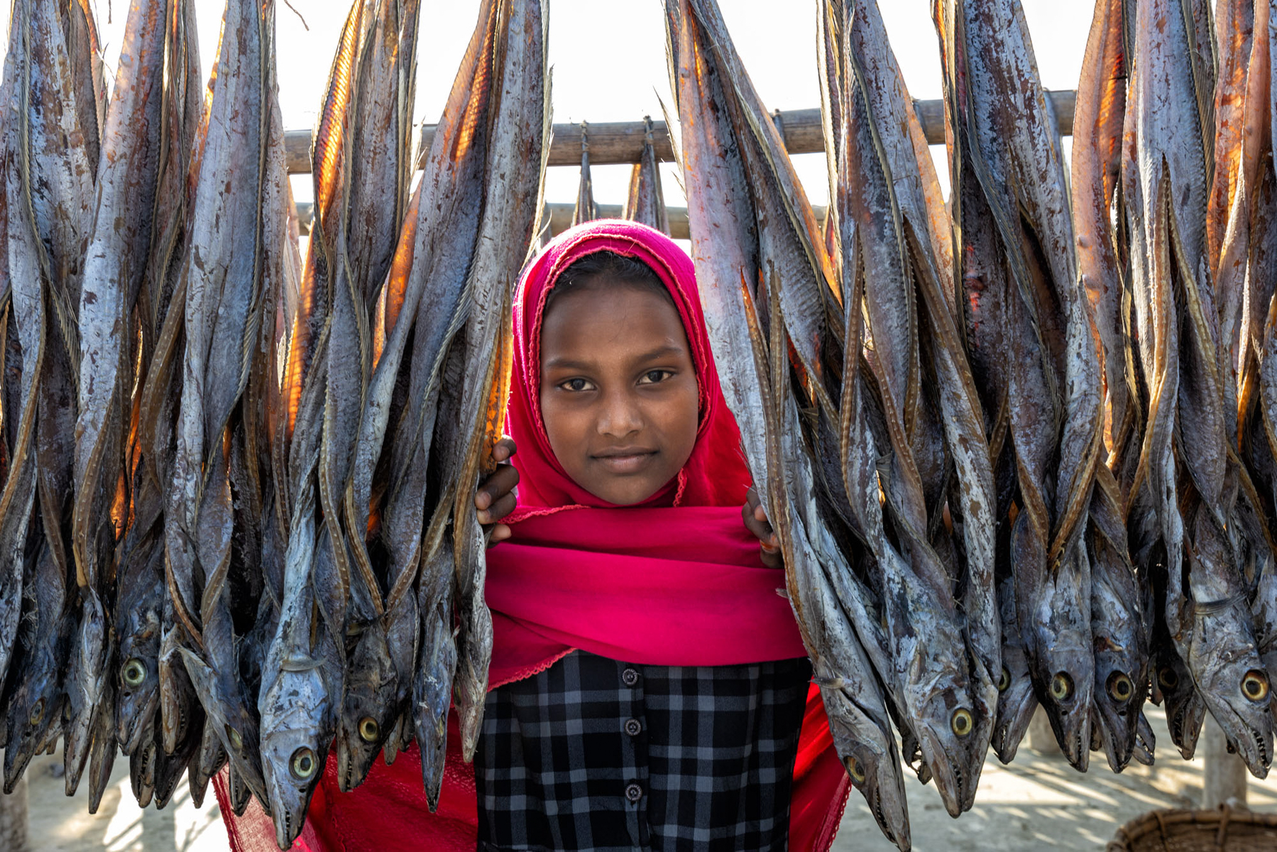 Young girl in the fish drying yards (image by Yousuf Tushar)