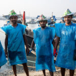 Fish carriers take a brief moment to stop for a photo (image by Yousuf Tushar)