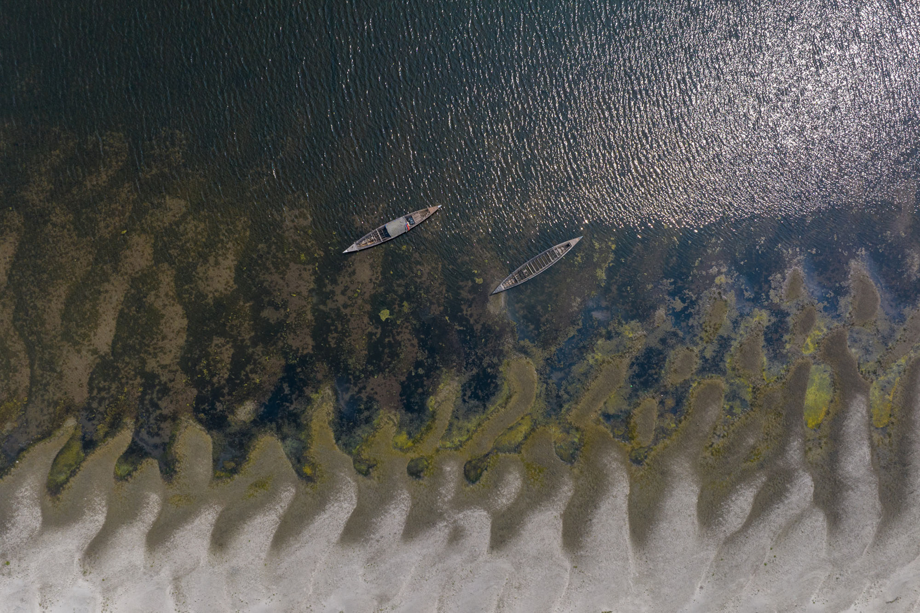 River house boats pierce the soft lines of evaporating waters in Bangladesh (image by Yousuf Tushar)