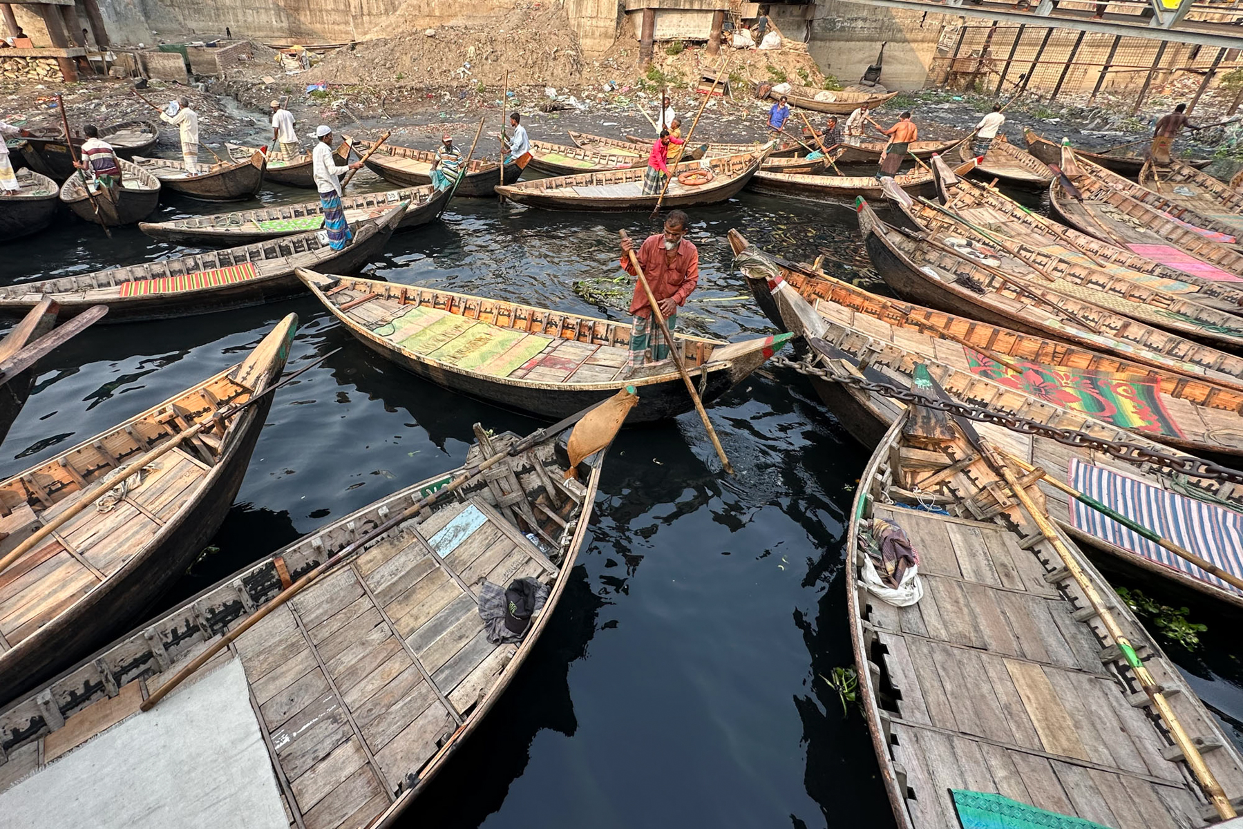 Every day, the city commuters of Dhaka cross the Buriganga in charismatic wooden boats. This is a typical 'taxi rank' (image by Yousuf Tushar)