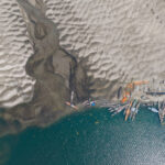 Aerial view of riverboats at the mouth of a tributary (image by Yousuf Tushar)
