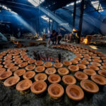 Shards of light pierce the floor of a yoghurt making factory in remote Bangladesh (image by Yousuf Tushar)