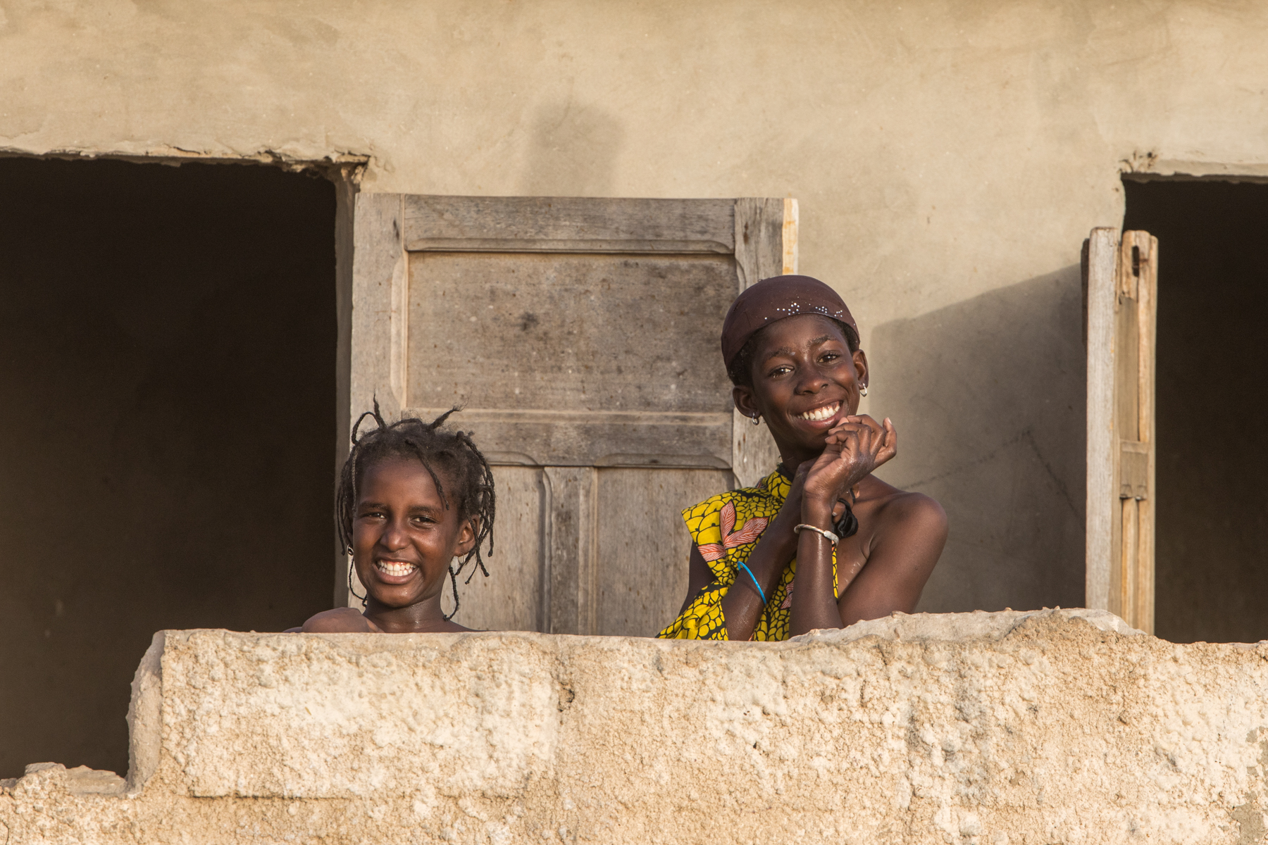 Giggling girls in a fishing village of Senegal. (image by Inger Vandyke)
