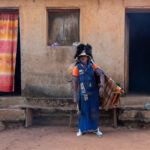 A Balafon Player outside his home (image by Inger Vandyke)