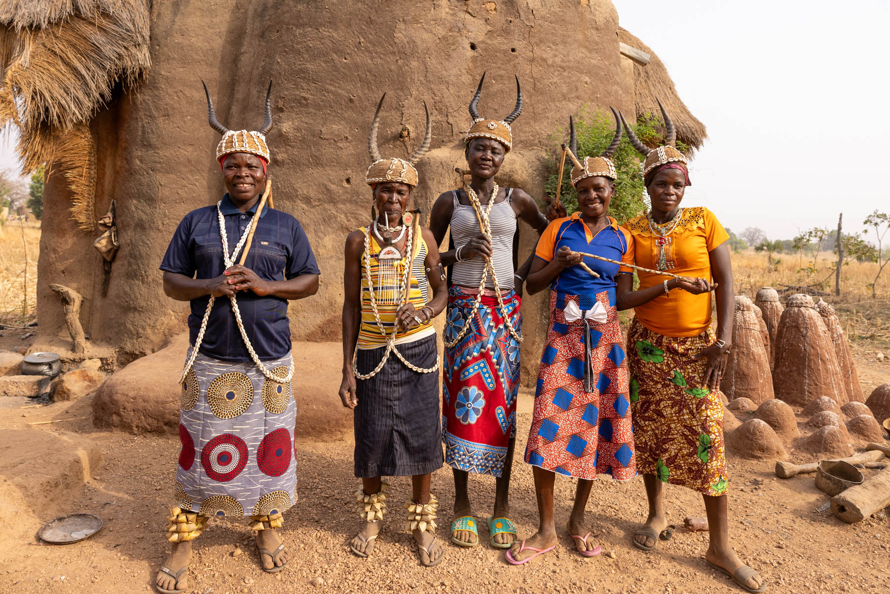 Batammariba women from Togo after a ceremony in front of a tata, wearing traditional hats decorated with cowrie shells and antelope horns (image by Ingrid Koedood)