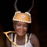 A gentle portrait of a Batammariba woman from Togo in ceremonial headwear: a cowrie-adorned hat with antelope horns (image by Ingrid Koedood)