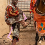 A Batonu horseman prepares to mount. Each strap and buckle is part of a tradition passed down through generations (image by Ingrid Koedood)