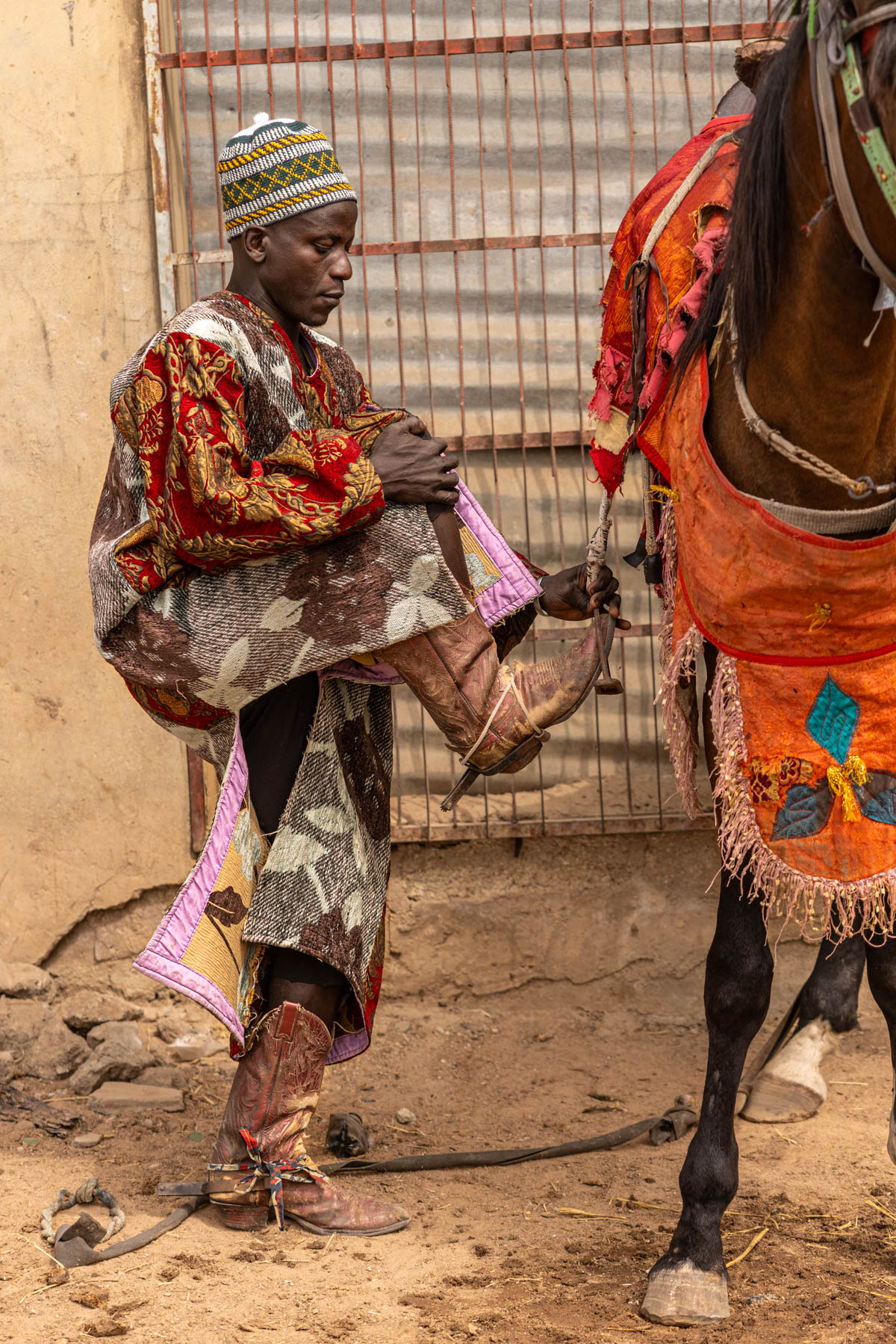 A Batonu horseman prepares to mount. Each strap and buckle is part of a tradition passed down through generations (image by Ingrid Koedood)