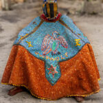 Egungun dancer covered in an elaborate costume of heavy fabrics and embroidery. The dancer becomes the visible form of an ancestor spirit (image by Ingrid Koedood)