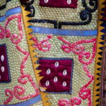 Close up: hand-embroided fabric of an Egungun costume, rich in symbols and color (image by Ingrid Koedood)