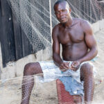 Fisherman mending nets at Grand Bassam (image by Inger Vandyke)