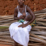A young woman breastfeeds her child during the Gambada ceremony (image by Ingrid Koedood)