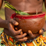 During the Gounouko mask ceremony a young man sprinkled water from a pot as ritual blessing, to purify and protect the ceremony (image by Ingrid Koedood)