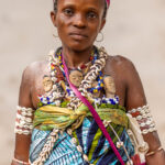 A beautiful Heviosso priestess in remote Benin. The twin dolls (often called ibejis) are carried to honour deceased twins, keeping their memory and spiritual presence alive (image by Ingrid Koedood)