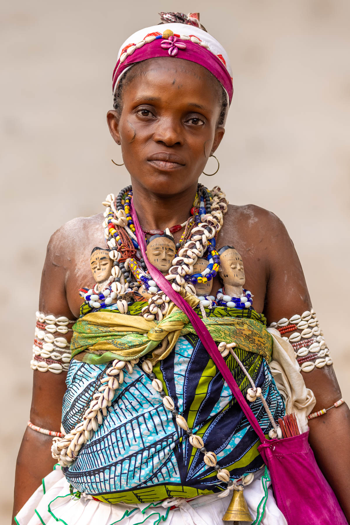 A beautiful Heviosso priestess in remote Benin. The twin dolls (often called ibejis) are carried to honour deceased twins, keeping their memory and spiritual presence alive (image by Ingrid Koedood)