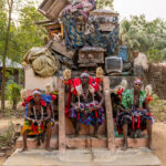 Heviosso Shamans. Heviosso is a powerful Vodun deity associated with thunder, lightning and fire. He is believed to protect the community, punish wrongdoing, and bring justice. They are seated in front of the alter where they expose the bodies and belongings of the bad people killed by the Heviosso (image by Ingrid Koedood)