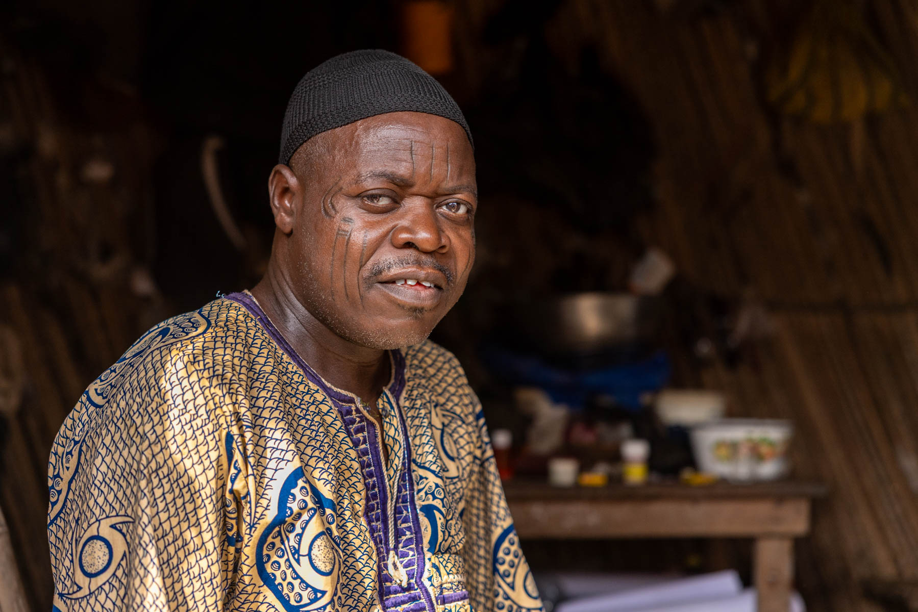 Portrait of a Holi man in front of his house with traditional scarification in his face (image by Ingrid Koedood)