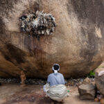 A quiet moment as a pilgrim makes an offering at Mont Sienlow (image by Inger Vandyke)