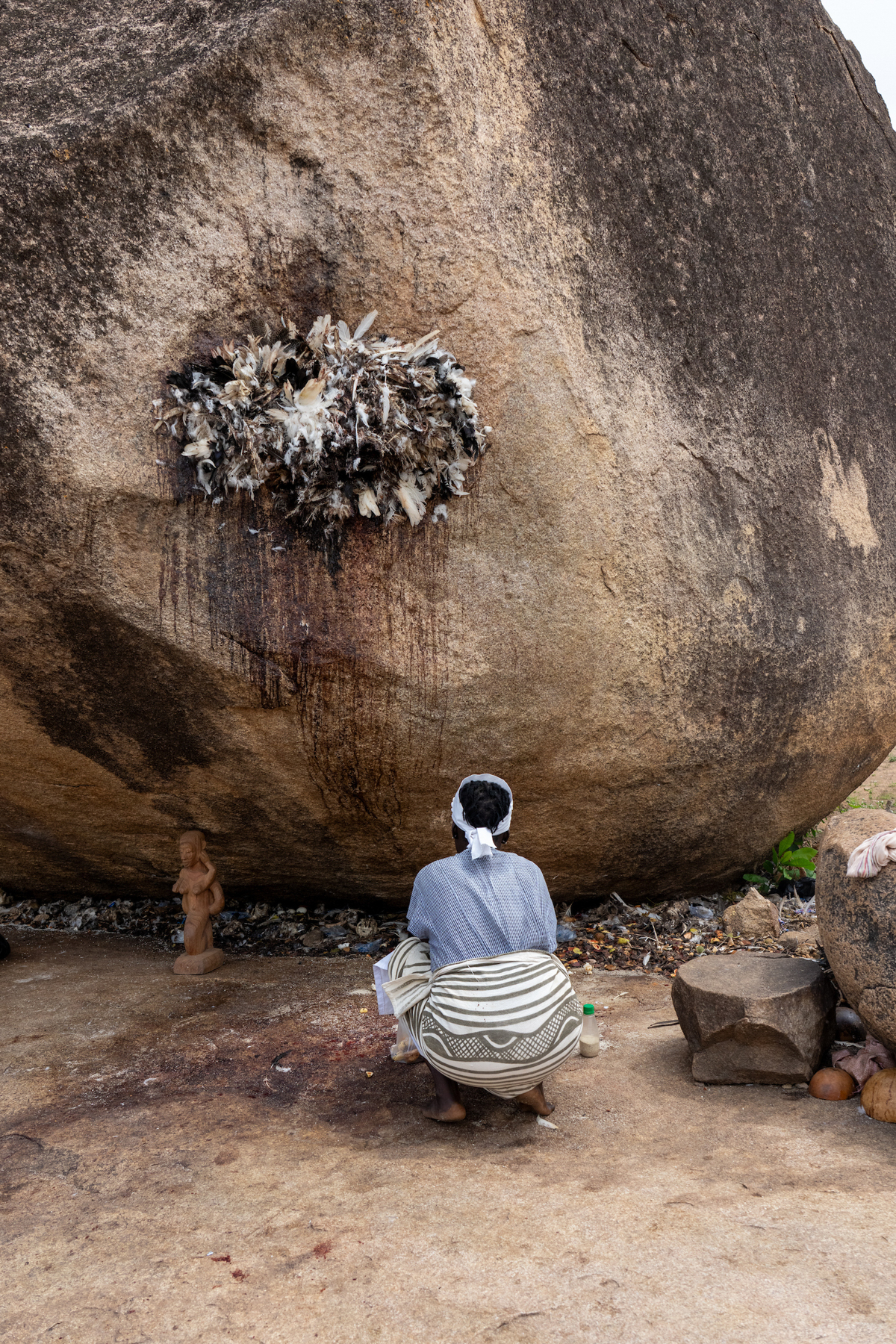 A quiet moment as a pilgrim makes an offering at Mont Sienlow (image by Inger Vandyke)