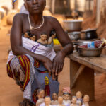 Portrait made after a twin ceremony. Twin dolls are carried and cared for as representations of twins who have died. Benin is known for its high number of twin births compared to the Western world (image by Ingrid Koedood)
