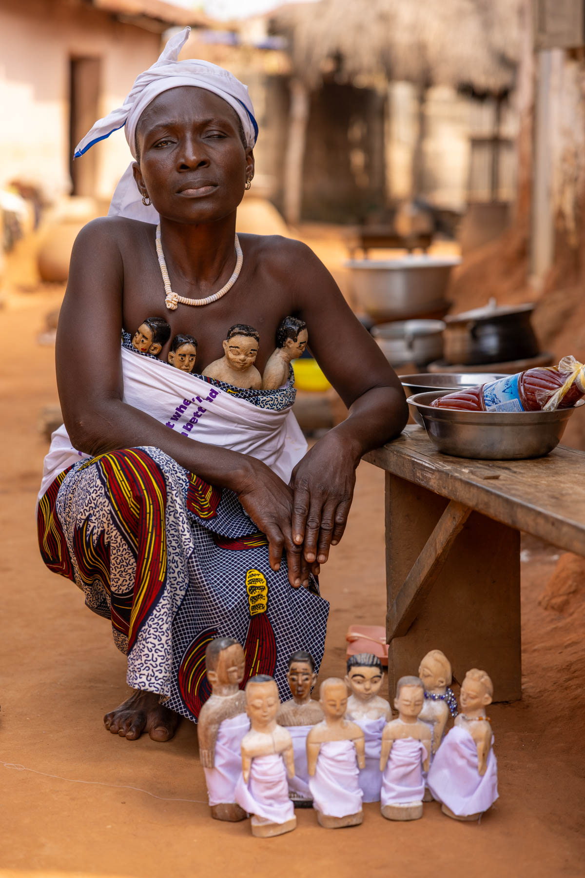 Portrait made after a twin ceremony. Twin dolls are carried and cared for as representations of twins who have died. Benin is known for its high number of twin births compared to the Western world (image by Ingrid Koedood)