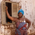 Portrait of a woman carrying twin dolls, also called Ibeji (image by Ingrid Koedood)