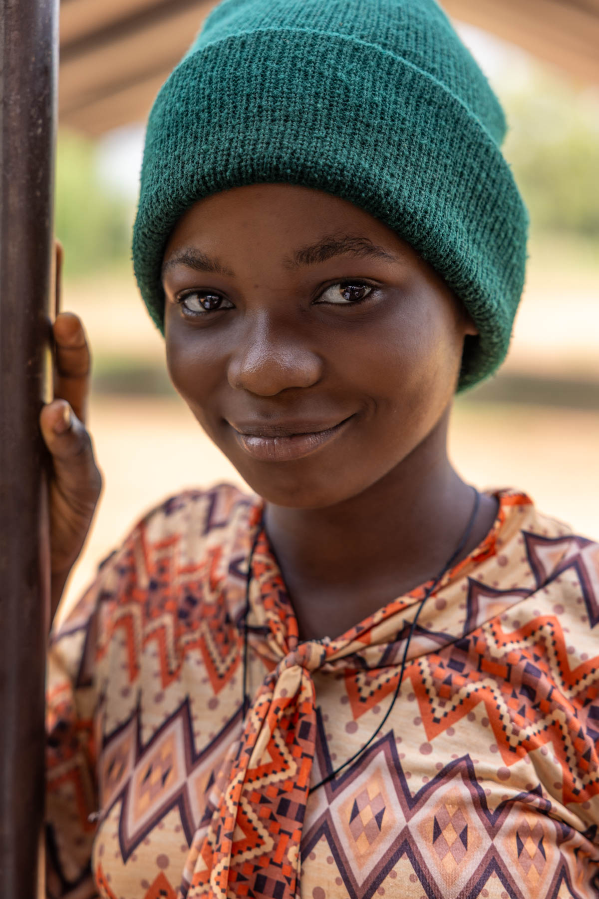 A young woman during Vodun Day, wearing a winter beanie despite the warm Beninese sun (image by Ingrid Koedood)