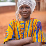 On our way to the Zangbeto ceremony we got caught in heavy rain. This girl came prepared (image by Ingrid Koedood)