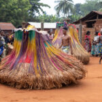 Zangbeto: the night guardians. The spirit figure spins in circles, guided and protected by a guard as it moves through the crowd (image by Ingrid Koedood)