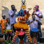 Zaouli dancer with musicians (image by Inger Vandyke)