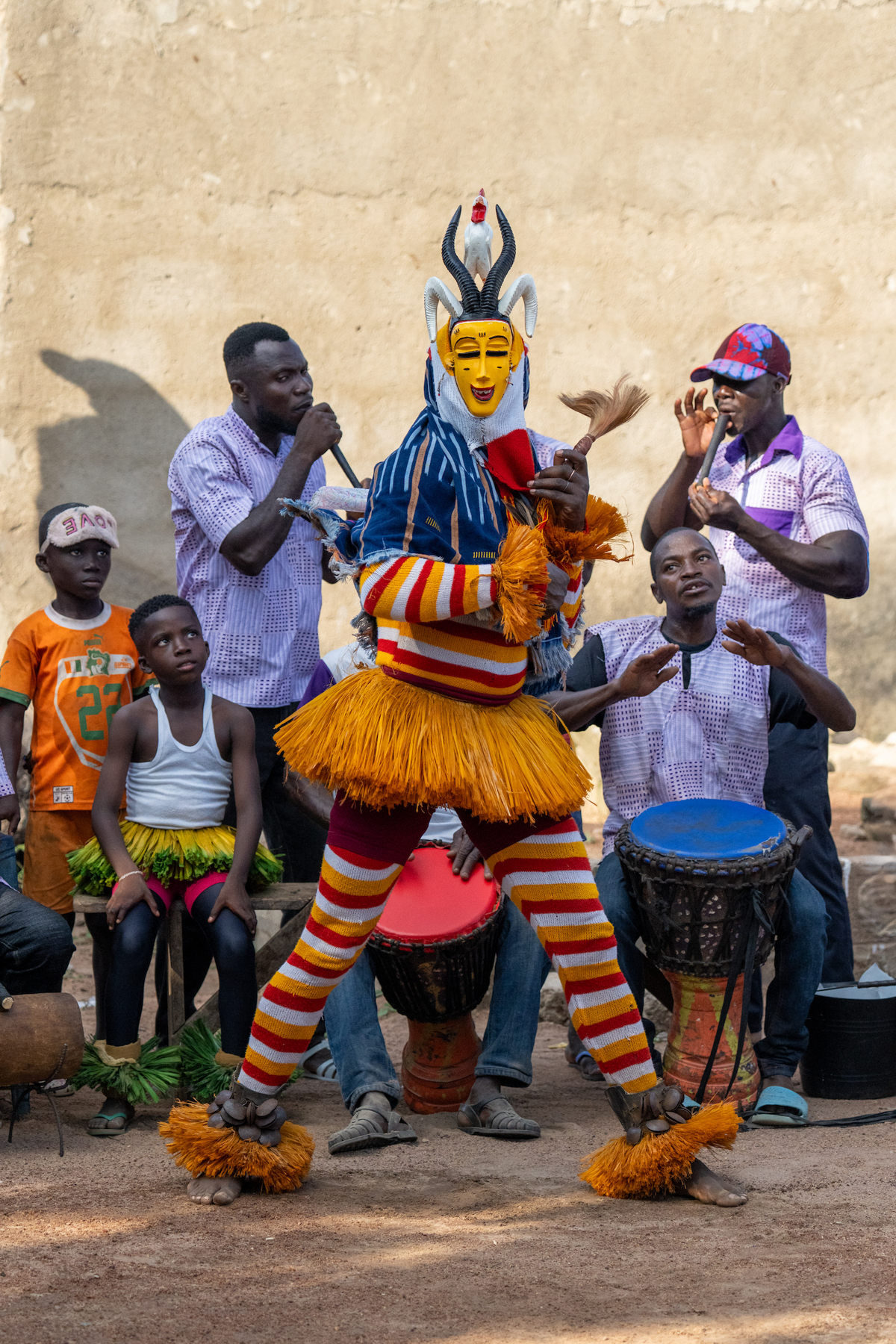 Zaouli dancer with musicians (image by Inger Vandyke)